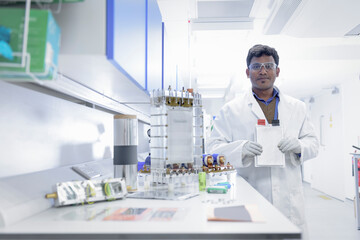 Portrait of scientist assembling lithium ion battery samples in battery research facility