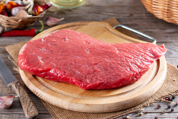 Raw meat, raw beef on a cutting board on a table