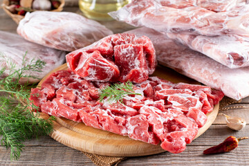 Frozen meat in a plastic bag on a table. Frozen food.