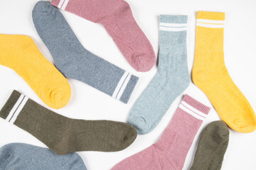 Multi colored warm socks with stripes isolated on white, top view