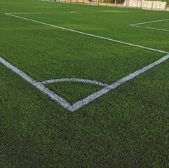 Fototapeta na wymiar Artificial grass soccer field. Corner kick line of ball and a soccer field , football field , background texture