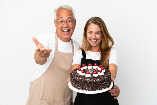 Middle Age Couple Chef Holding Birthday Cake Isolated On White Background