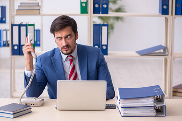 Young male employee working in the office