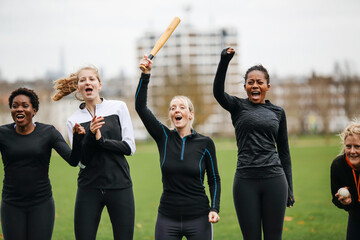 Female rounders team cheering at rounders match