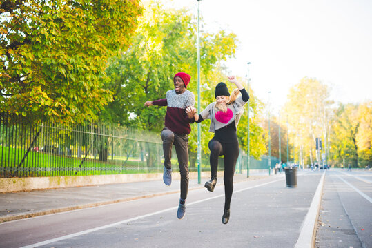 Couple skipping on street