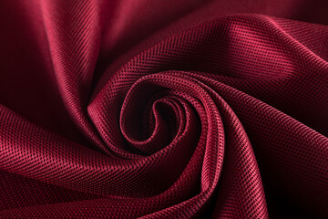 burgundy neoprene fabric rolled into a spiral