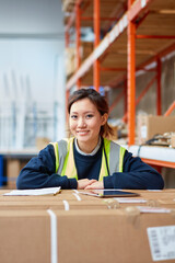 Portrait of female factory worker in factory warehouse