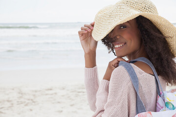 Young woman wearing hat on beach