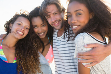 Portrait of young man and three female best friends on beach, Cape Town, South Africa