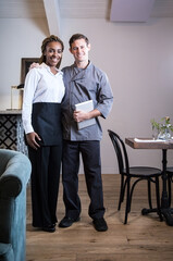 Obraz premium Portrait of male and female waiting staff in restaurant