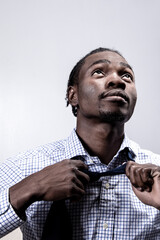 Young man undoing neck tie