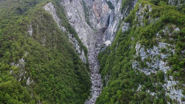 Flying through a canyon towards a huge waterfall in Slovenia.