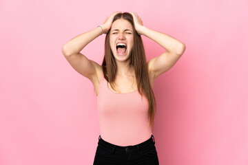 Young caucasian woman isolated on pink background stressed overwhelmed