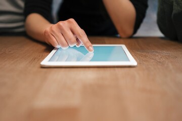 Cropped view of woman using digital tablet