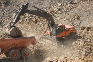 Quarry worker operating heavy machinery in quarry