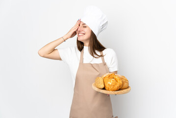 Young woman in chef uniform isolated on white background laughing