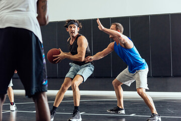 Fototapeta na wymiar Male basketball players defending ball in basketball game