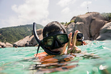 Young man and woman snorkelling, Nangyuan Island, Thailand