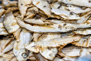 A pile of dried salted fish in a seafood market with selective focus