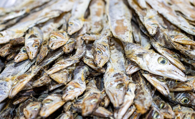 Close up view of a pile of dried sea fish on a seafood market with selective focus