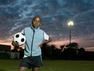 Teenage african boy with football © Image Source Limited