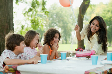Children at birthday party with birthday cake