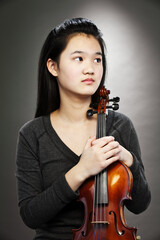 Portrait of young Asian teenage girl holding violin