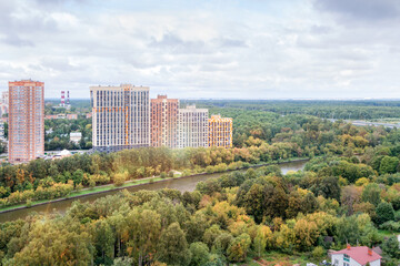 High rise apartment building exterior multi-family residential district area development overcast forest river bank