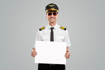 Cheerful pilot with blank banner