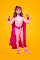 Strong superhero kid in pink outfit