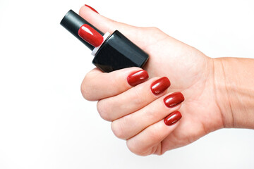 Manicure. jar with nail polish in a womans hand. shellac.