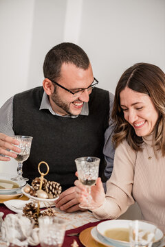 Crop Happy Couple With Champagne Celebrating Christmas Day At Home