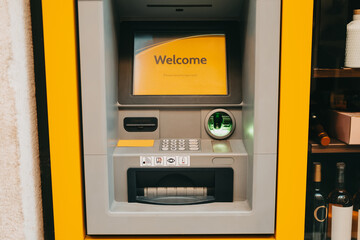 ATM machine, close-up. Automated teller machine built into the building facade.