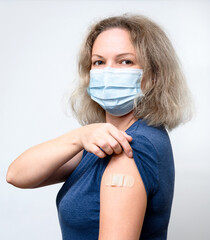 Vaccinated young woman showing shoulder after COVID-19 vaccine getting - obrazy, fototapety, plakaty