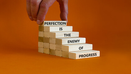 Perfection or progress symbol. Wooden blocks on orange background, copy space. Businessman hand....