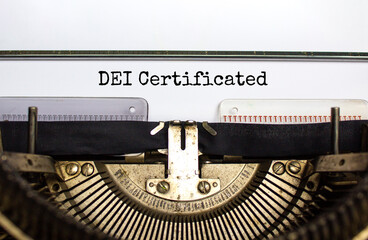 DEI, diversity equity inclusion certificated symbol. Concept words 'DEI certificated' typed on old retro typewriter. Business, DEI, diversity equity inclusion certificated concept. Copy space.