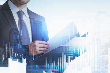 Businessman wearing formal suit is holding and reading notebook