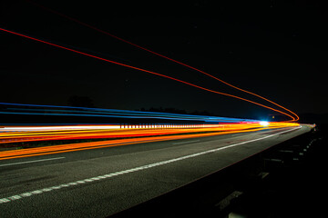 Night road lights. Lights of moving cars at night. long exposure red, blue, green