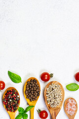 Assortment of spices, herbs and cherry tomatoes on white marble background. Cook book cover template. 