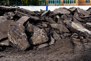 Pieces of asphalt on the side of the road.Reconstruction of the coating