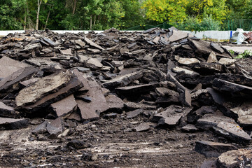 Pieces of asphalt on the side of the road.Reconstruction of the coating