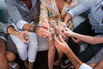 Group of young friends toasting sparkling white wine glasses at outdoor party - Friendship...