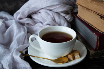 old books, tea, on a dark table