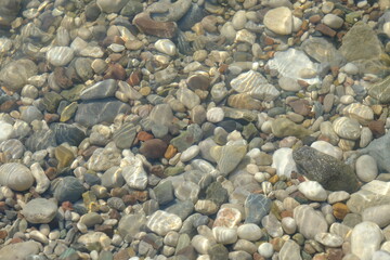 Pebbles on the beach.Colorful pebbles under clear water.