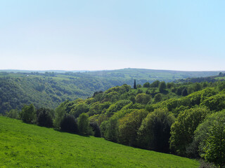 Fototapeta na wymiar view of the valley and woodland looking over hardcastle crags with war memorial in calderdale west yorkshire
