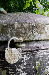 Close up of an old dirty padlock on a bunker