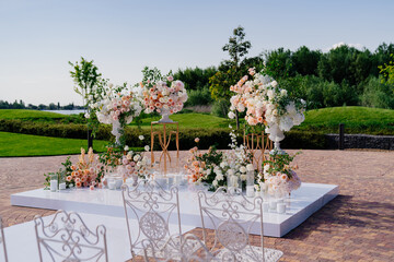 the wedding ceremony in the open air of fresh flowers, with candles