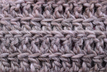 Close-up knitted wool texture in natural grey color.