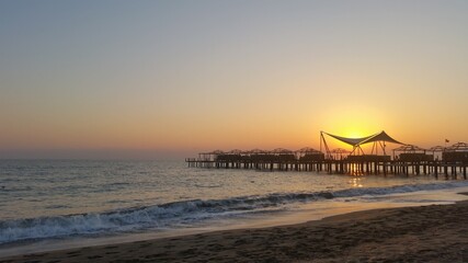 Sunset at the pier, sunset on the beach.