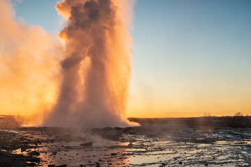 Eruption of the Geysir in Iceland during the sunrise